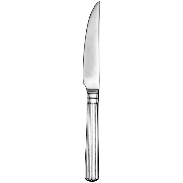 A close up of a Walco stainless steel steak knife with a silver handle.