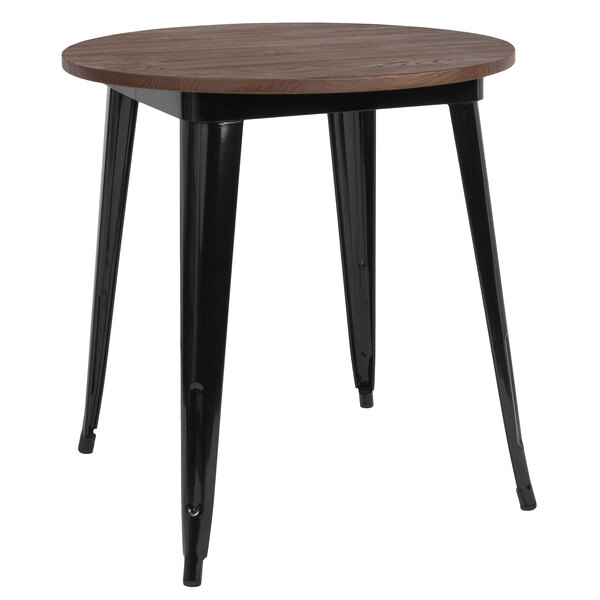 A Flash Furniture round dining table with a black metal frame and walnut top.