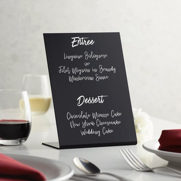 An American Metalcraft tabletop chalkboard sign with a menu on a table.