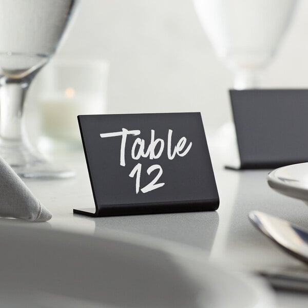 An American Metalcraft tabletop chalkboard sign with a table number on it.