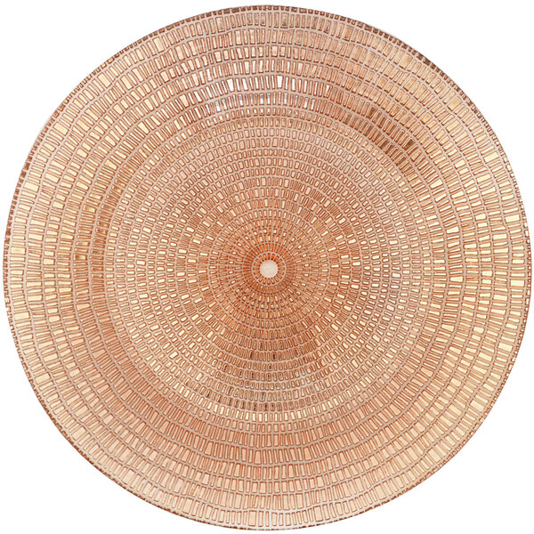 A close up of a Bon Chef rose gold glass charger plate with a pattern.