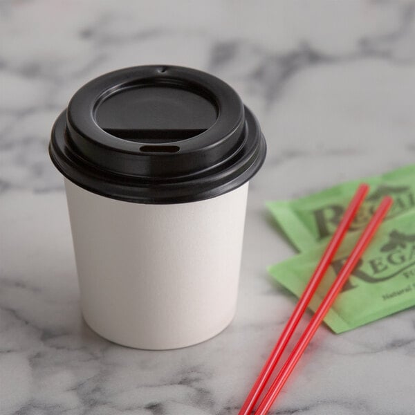 A black Choice hot paper cup lid on a white paper cup of coffee.