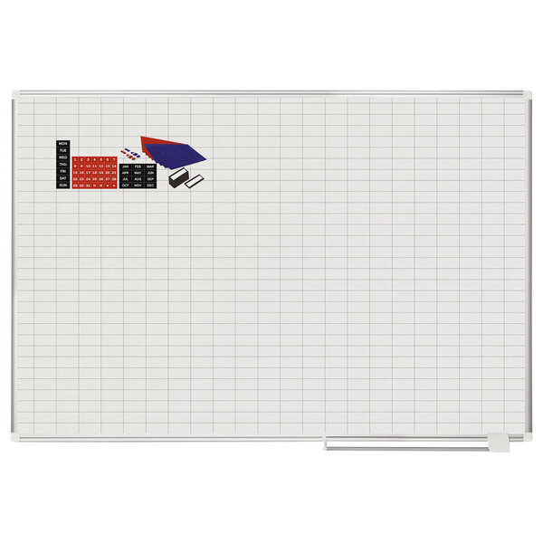 A whiteboard with a grid and accessories on it.