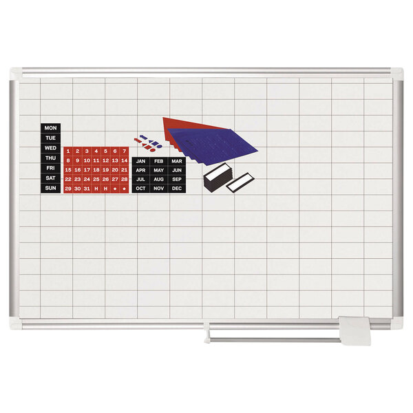 A white MasterVision grid planning board with red and blue magnets on a white background.