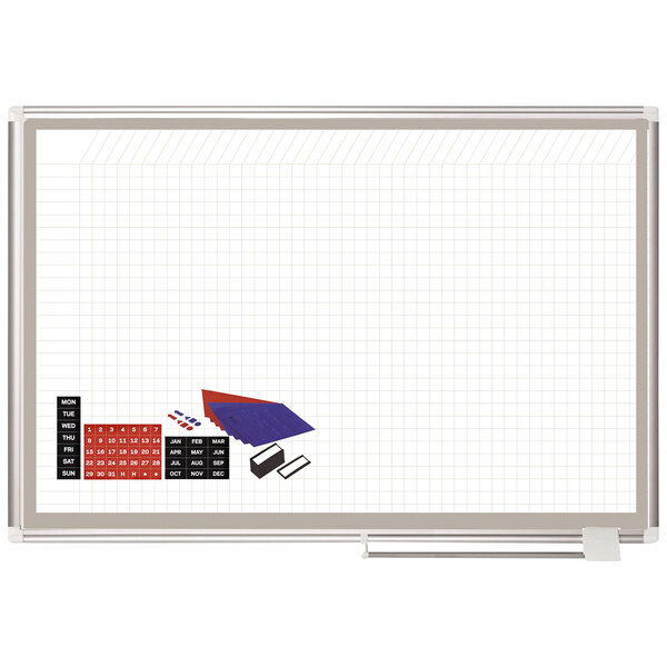 A white MasterVision grid porcelain planning board with grid paper and accessories.