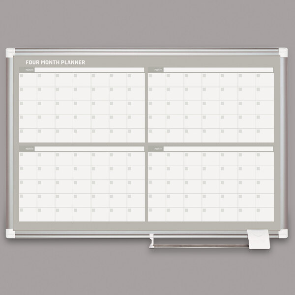 A white MasterVision dry erase board with a calendar.