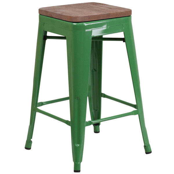 A green Flash Furniture metal backless counter height stool with a square wooden seat on a table.