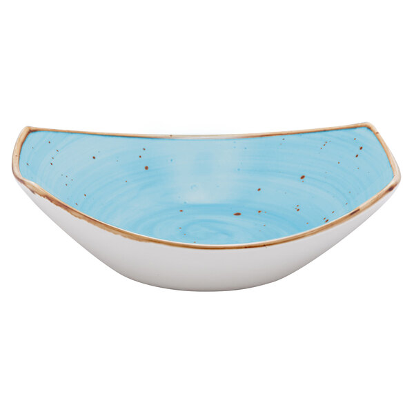 A white china bowl with blue and brown specks and gold trim.