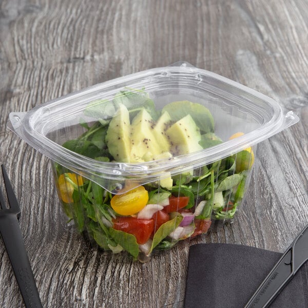 A salad in a rectangular Eco-Products deli container with a yellow tomato.