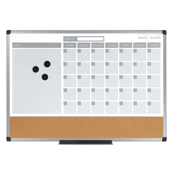 A white board with a monthly calendar on it.