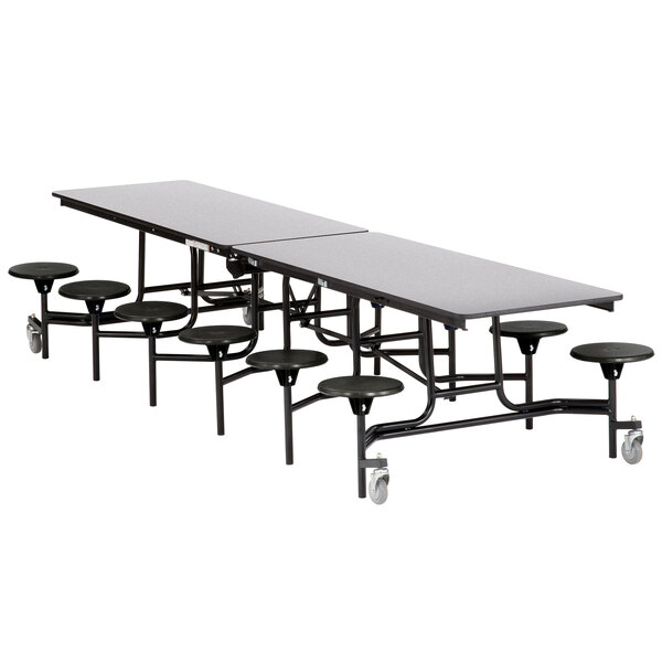 A black rectangular table with metal legs and 12 black stools with metal legs.