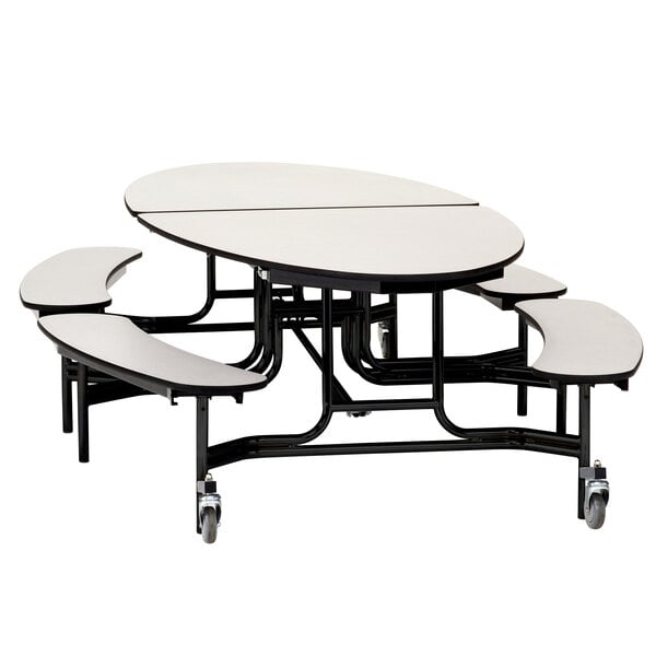 A white elliptical National Public Seating cafeteria table with black T-mold edges and benches on wheels.