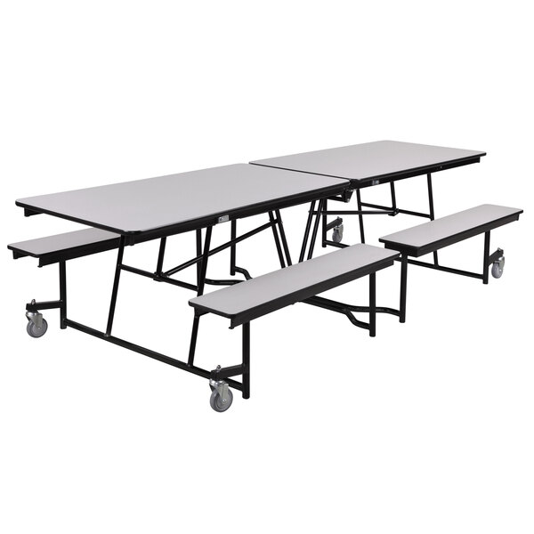 A white rectangular National Public Seating cafeteria table with benches on wheels.