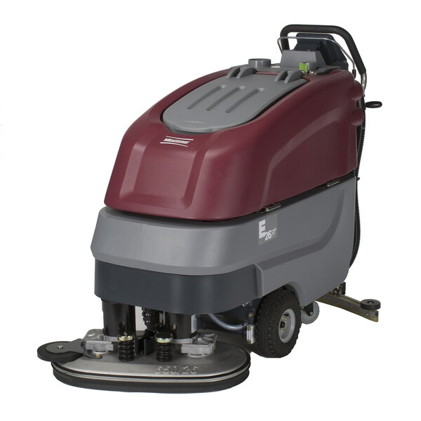 A red and grey Minuteman E26 cordless walk behind floor scrubber with wheels and a handle.
