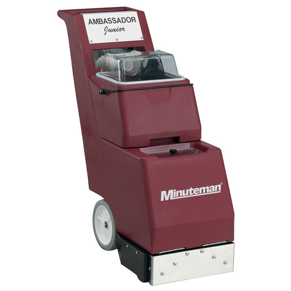 A red and white Minuteman Ambassador Junior carpet extractor with a clear cover and wheels.