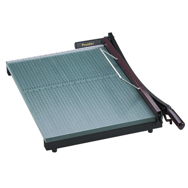 A Premier green and black paper cutter with a grid and a handle on a white background.