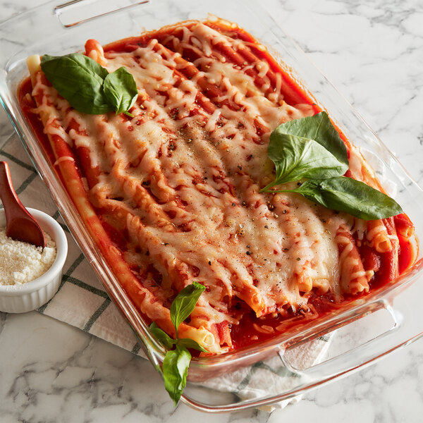 A casserole dish filled with long ziti pasta and sauce.