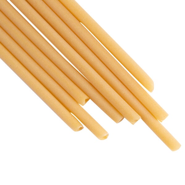 A group of long thin yellow pasta on a white background.