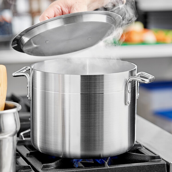 Cook with big cooking pot in the kitchen stock photo