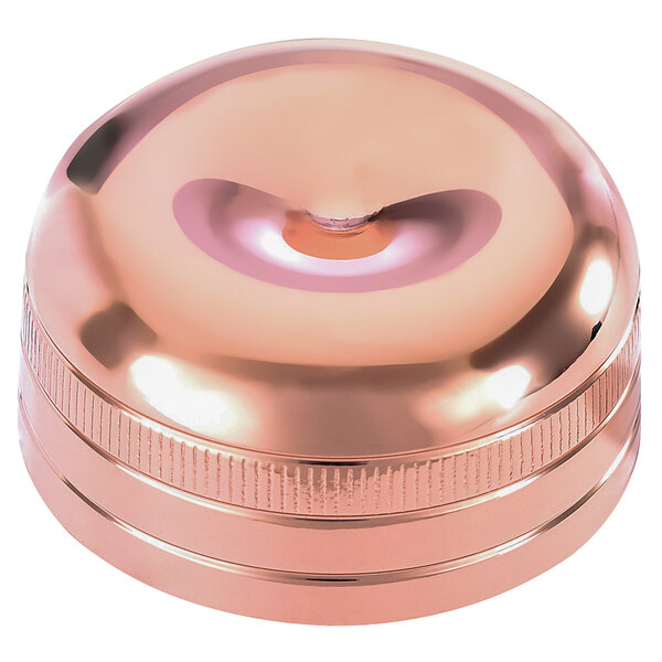 A copper-plated metal lid for a cocktail shaker.