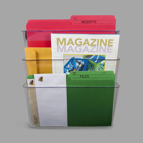 A clear Storex wall file with three pockets holding green and white folders.