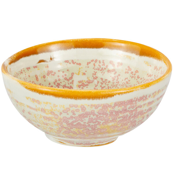 A Bon Chef Tavola Blush porcelain bowl with a speckled pattern in yellow and white.