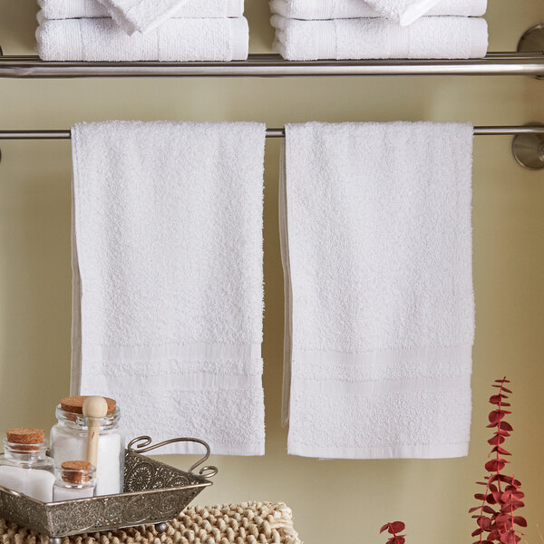 A white Lavex hand towel on a rack.