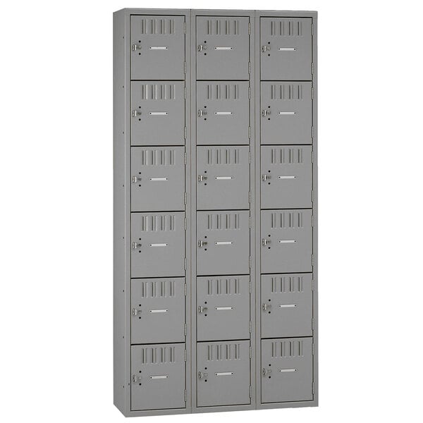 A group of gray Tennsco steel lockers with eighteen compartments.