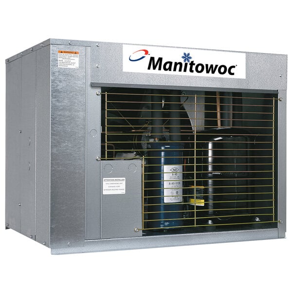 A large metal box with a large black cylinder inside, labeled Manitowoc.