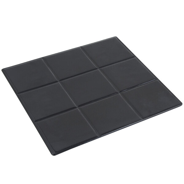 A black square Bon Chef tile with four squares.