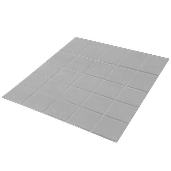 A white tile with a square pattern.
