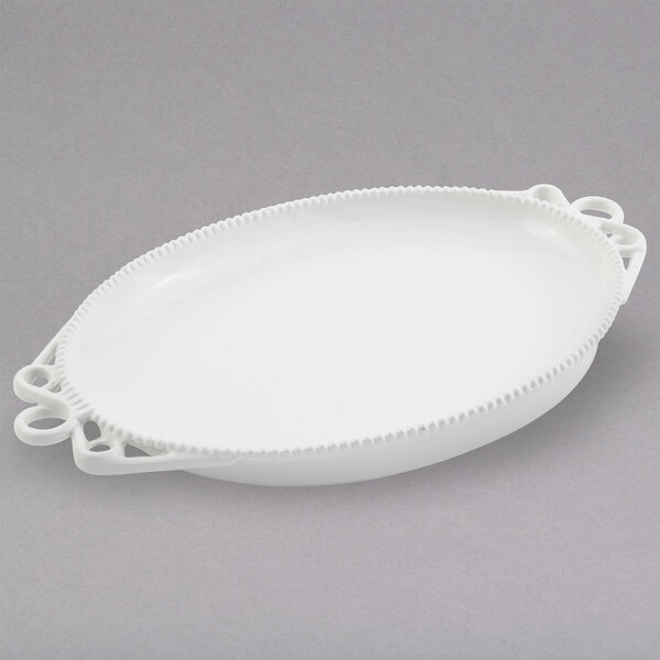 A white oval Bon Chef cast aluminum platter with handles.