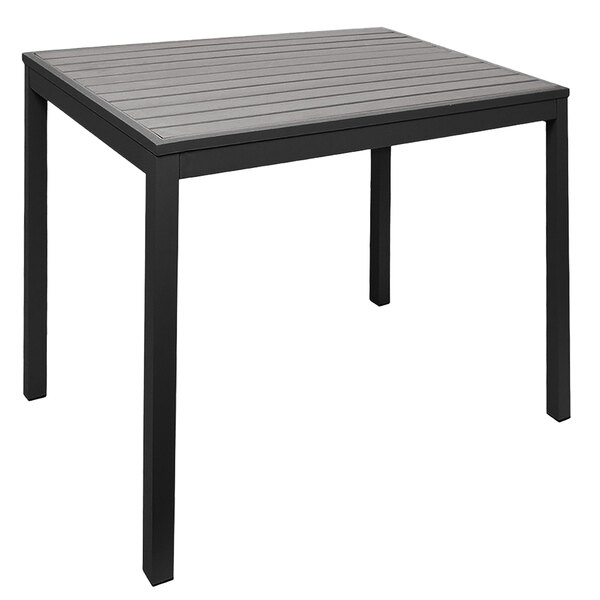 A BFM Seating black metal table with a gray synthetic teak top.