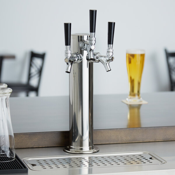 An Avantco silver beer tap on a counter.