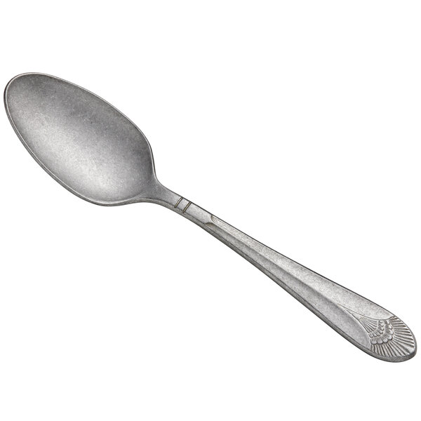 A Libbey silver bouillon spoon with a design on the handle.