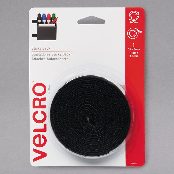 A package containing a roll of black Velcro tape with a dispenser.