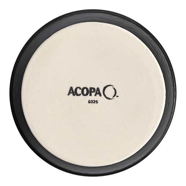 A round stoneware ramekin with a black rim and the Acopa brand name on the bottom.
