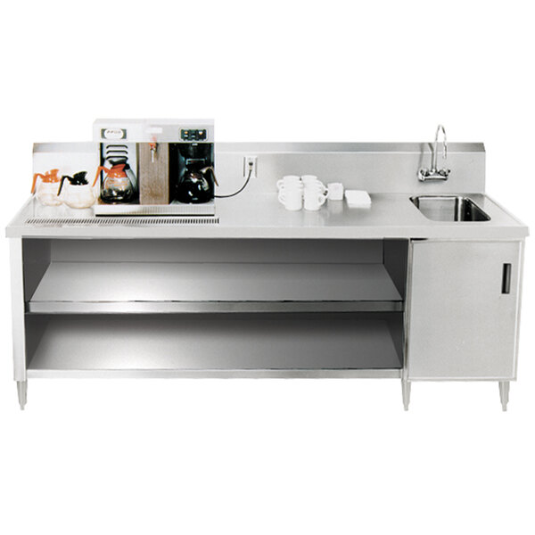 A stainless steel Advance Tabco beverage table with a sink on the counter.