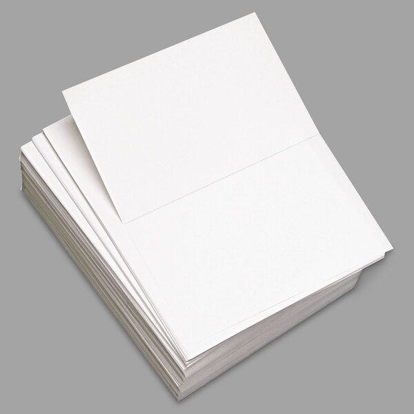 A stack of white paper with perforated edges.
