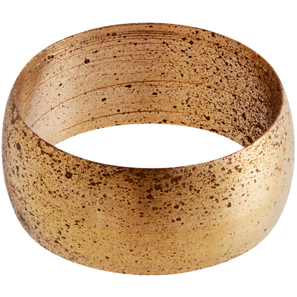 A gold ring with speckles on a white background.