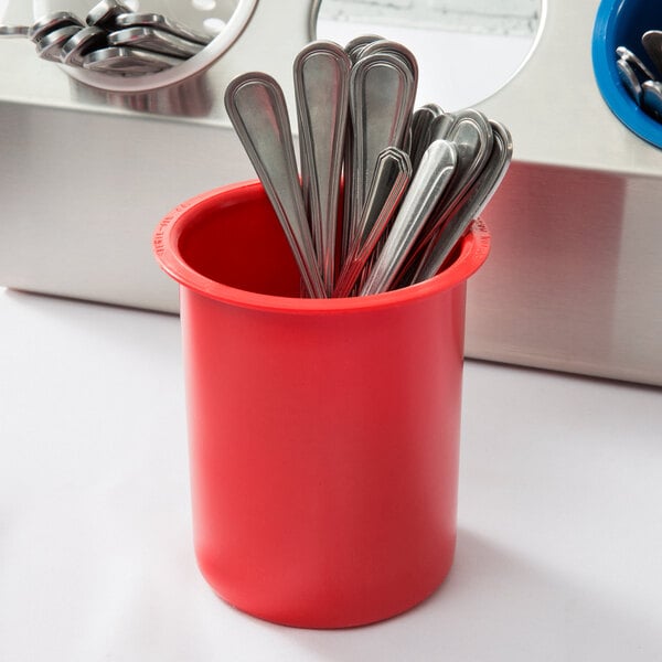 A red Steril-Sil flatware cylinder with silverware in it.