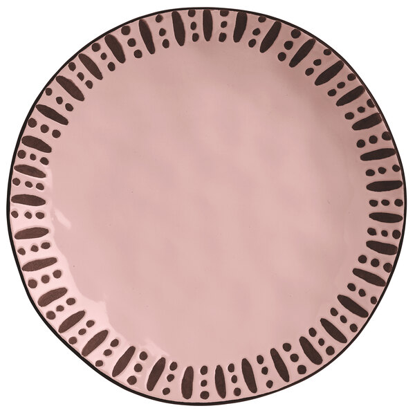 A white stoneware dinner plate with a pink top and black dots.