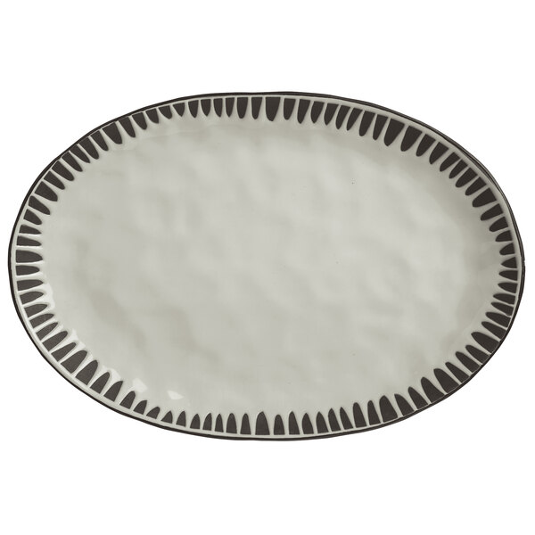 A white and gray stoneware platter with an oval shape and black design.