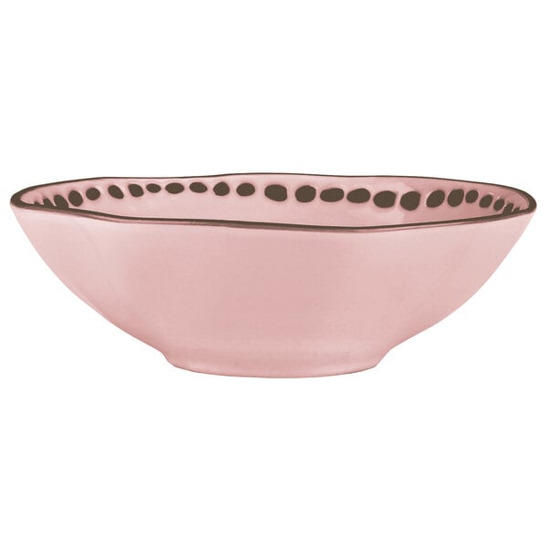 A pink stoneware bowl with black trim.