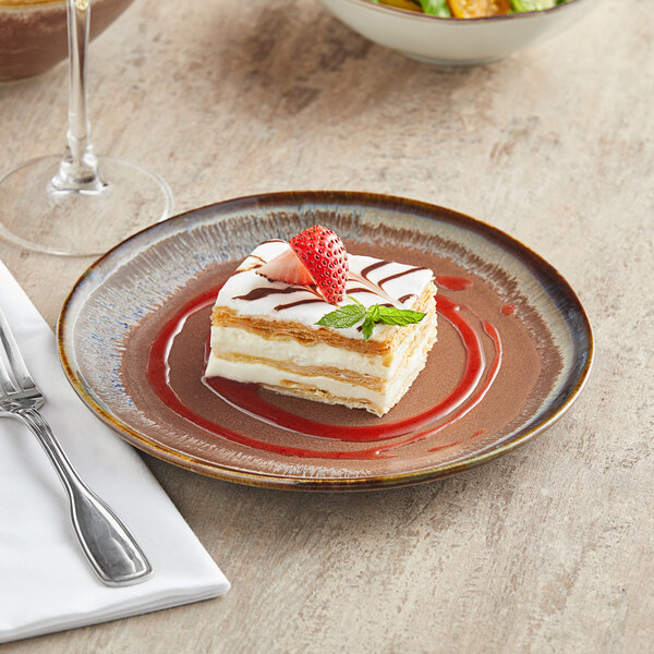 A Libbey Hedonite porcelain plate with a piece of cake with a strawberry on top on it.