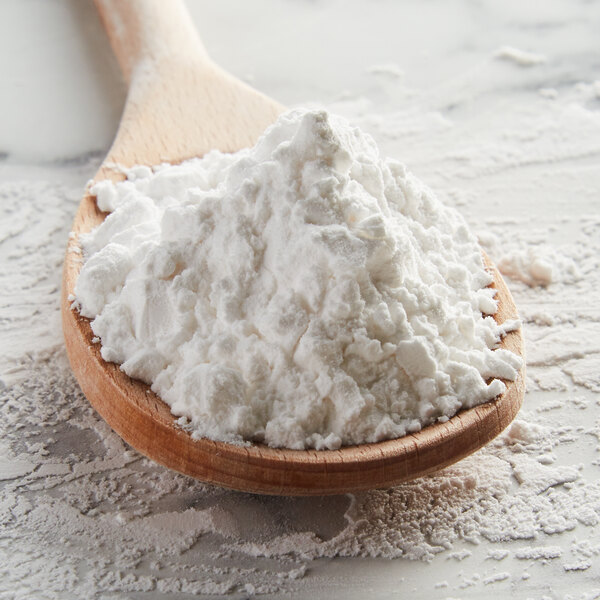 A wooden spoon filled with Regal arrowroot powder.