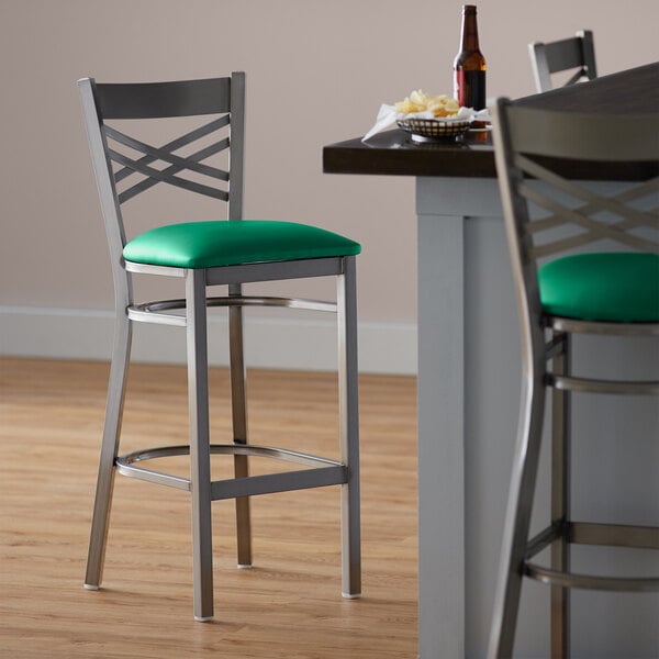 Lancaster Table & Seating Clear Coat Finish Cross Back Bar Stool with 2 1/2" Green Vinyl Padded Seat - Assembled