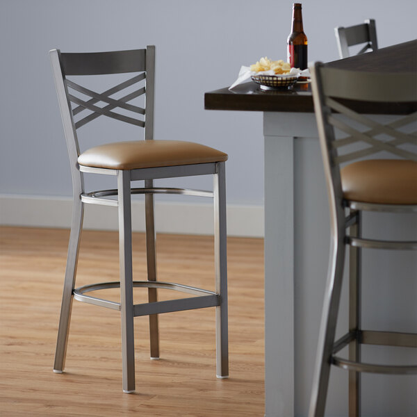 Lancaster Table & Seating Clear Coat Steel Cross Back Bar Height Chair with 2 1/2" Light Brown Vinyl Seat - Preassembled
