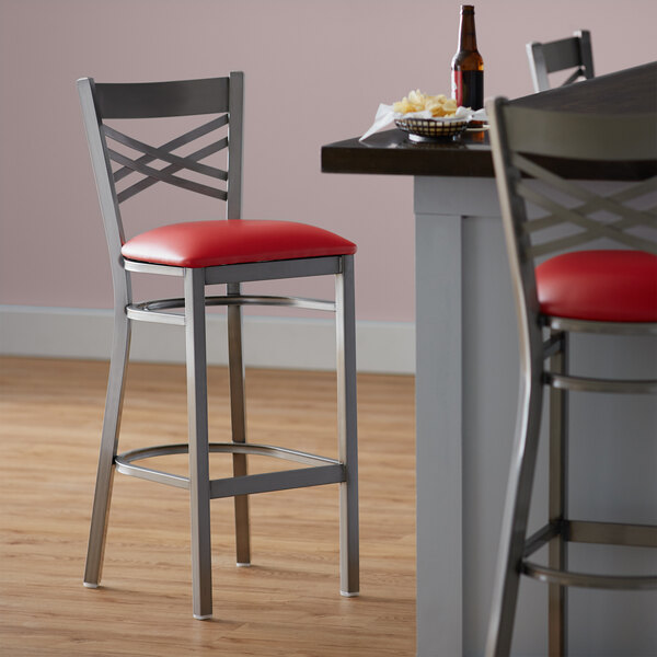 Lancaster Table & Seating Clear Coat Finish Cross Back Bar Stool with 2 1/2" Red Vinyl Padded Seat