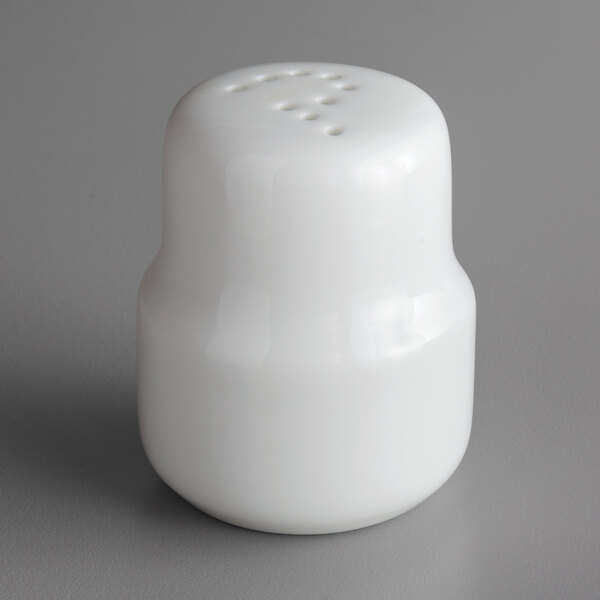 A white porcelain pepper shaker with holes.